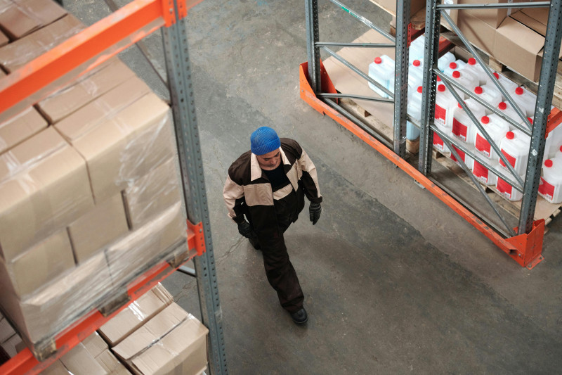 person walking in storage warehouse.